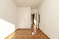 Empty bedroom with oak parquet floor laid in a checkerboard pattern,