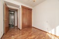 Empty bedroom with shiny reddish parquet floor, matching fitted wardrobes Royalty Free Stock Photo