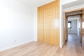 Empty bedroom with three section wardrobe in cherry wood