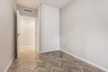 Empty bedroom with white door, built-in wardrobes, herringbone Royalty Free Stock Photo