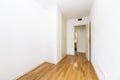 Empty bedroom with white wooden built-in wardrobe doors and ducted air conditioning, white painted walls and wooden floors Royalty Free Stock Photo