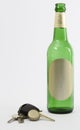 Empty beer bottle with car key and crown cork