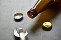 Empty beer bottle opener and gold bottle caps Royalty Free Stock Photo