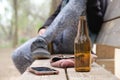Empty beer bottle, smartphone and wallet on a park bench