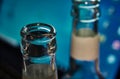 Empty beer bottles, upper part, in front of a switched on Momitor. Selective focus. Concept for alcohol abuse and alcohol Royalty Free Stock Photo