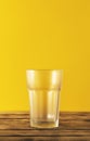 Empty beer glass, bottle beer on a wooden background and yellow, selective focus. Royalty Free Stock Photo