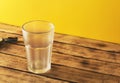 Empty beer glass, bottle beer on a wooden background and yellow, selective focus. Royalty Free Stock Photo