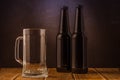 empty beer glass and two bottles/ empty beer glass and two bottles on a bar Royalty Free Stock Photo