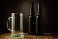 empty beer mug and bottle on a dark background/empty beer mug and bottle on a dark background. Selective focus Royalty Free Stock Photo