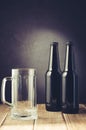 empty beer mug and bottle/ empty beer mug and bottle on a dark style. Selective focus Royalty Free Stock Photo