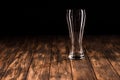 empty beer mug at wooden table on black background minimalistic Royalty Free Stock Photo