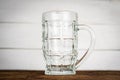 Empty beer pint, mug on wooden table. Close up Royalty Free Stock Photo