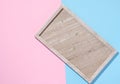 Empty beige rectangular marble plate on a blue pink background