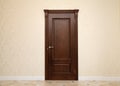 Beige room interior with brown wooden door Royalty Free Stock Photo