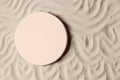 Empty beige round platform podium for cosmetics or products presentation on natural beige beach sand background. Wavy Royalty Free Stock Photo