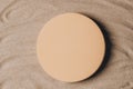 Empty beige round platform podium for cosmetics or products presentation on natural beige beach sand background. Wavy Royalty Free Stock Photo