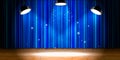 Empty beige wooden stage with blue drape and bright light