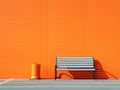 an empty bench against an orange wall