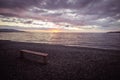 Empty bench on beach at sunset, marsala toned Royalty Free Stock Photo