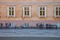 empty bench and bicycles parked near old house on street