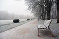 Empty bench in covered hoar-frost park a winter day Royalty Free Stock Photo