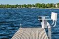 An empty bench on the end of a dock overlooking a Minnesota lake Royalty Free Stock Photo