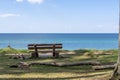 Empty bench in front of a tranquil sea Royalty Free Stock Photo