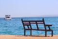 Empty bench near sea and shipped ship. Loneliness. Departure of ship. Bench near beach