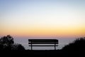 Empty bench overlooking the colorful light of sunset over the ho Royalty Free Stock Photo