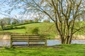 Empty Bench overlooking River Bank of the River Weaver in Cheshire