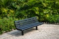 Empty bench in park - wooden bench in tropical garden Royalty Free Stock Photo