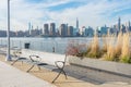 Empty Bench with Plants at a Park in Greenpoint Brooklyn New York looking out towards the East River and the Manhattan Skyline Royalty Free Stock Photo