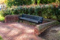 Empty Bench with Roses in Background on a Public Park Royalty Free Stock Photo