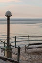 empty bench at sea beach on sunset Royalty Free Stock Photo