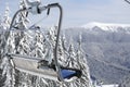 Empty bench on ski lift against winter mountains Royalty Free Stock Photo