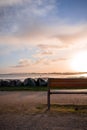 Rivedoux-plage, re island. . Empty bench at sunrise with the bridge of Ile de Re in the background. tranquility concept.