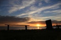 An empty bench and the river in the park at sunset. Royalty Free Stock Photo