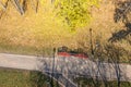 Empty benches in the autumnal park. footpath with fallen leaves and long shadows. aerial photo Royalty Free Stock Photo