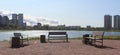 Empty benches from behind. Idyllic place in nature in front of a lake. A quite place to relax without people.