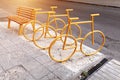 Empty bicycle parking city park with yellow bench on the background Royalty Free Stock Photo