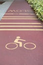 Empty bicycle way for bike in a park with slow sign Royalty Free Stock Photo