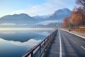 empty bike lane by picturesque lake with misty mountains