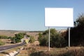 Empty billboard for advertising poster near asphalting road. Background of blue sky and beautiful nature. Royalty Free Stock Photo