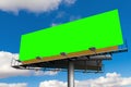 Empty billboard with chroma key green screen, on blue sky with c Royalty Free Stock Photo