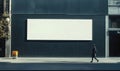 Empty billboard with pedestrian walking, urban setting, modern architecture, shadows, minimalism Royalty Free Stock Photo