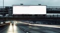 An empty billboard with space for text is above a wide-lane highway Royalty Free Stock Photo