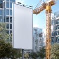 Empty Billboard Standing Tall Against a Backdrop of Modern City Buildings and Construction Site Under Clear Blue Sky Royalty Free Stock Photo