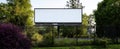 The empty billboard surrounded by lush greenery and peaceful surroundings. AI generated image Royalty Free Stock Photo