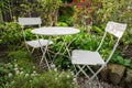 Empty bistro coffee table with chairs in garden