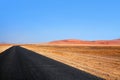 Empty black asphalt long road, Namib desert dunes and blue sky background, transportation design template, nobody, copy space Royalty Free Stock Photo